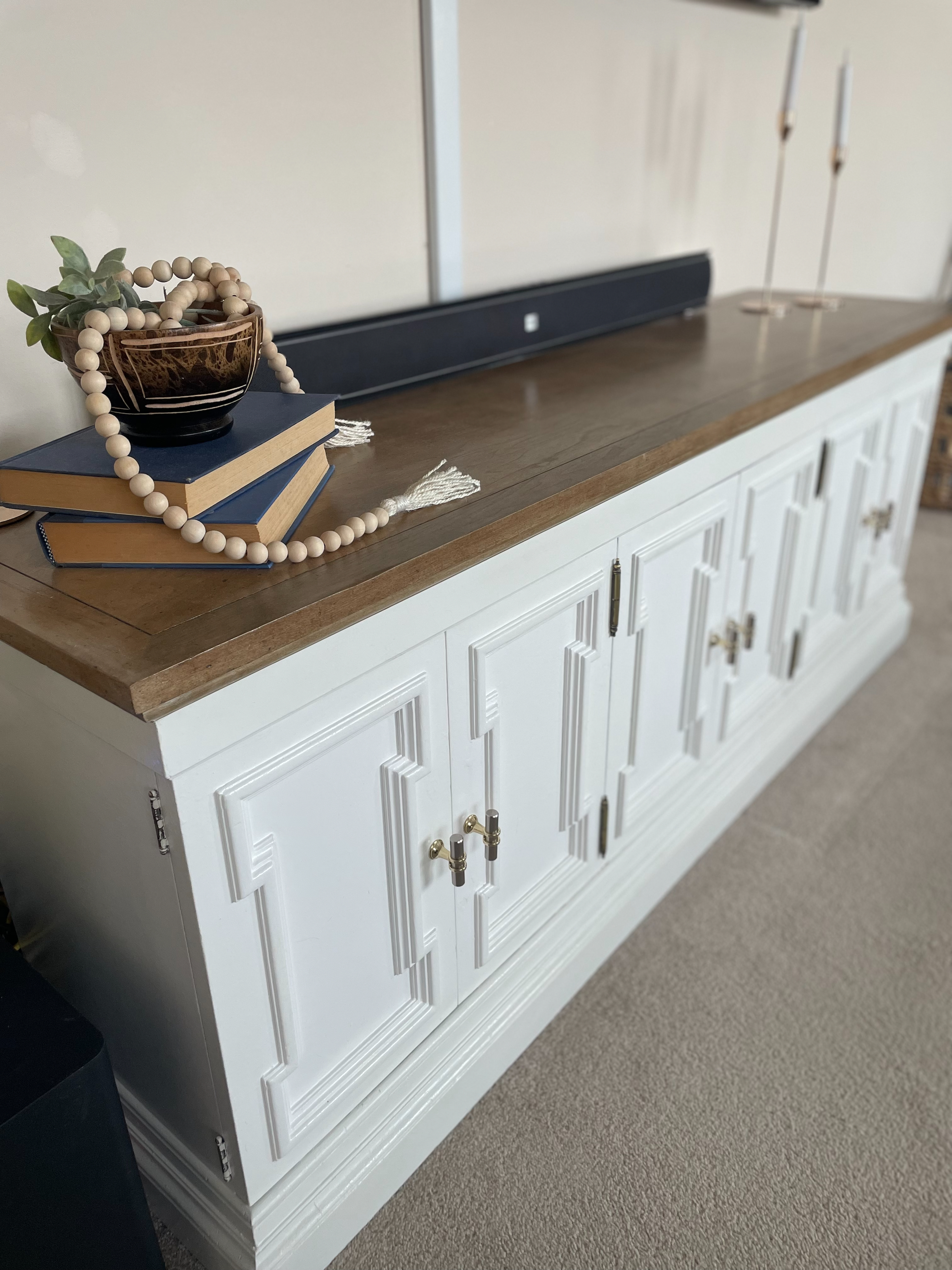 white refinished buffet table with decorative beads 