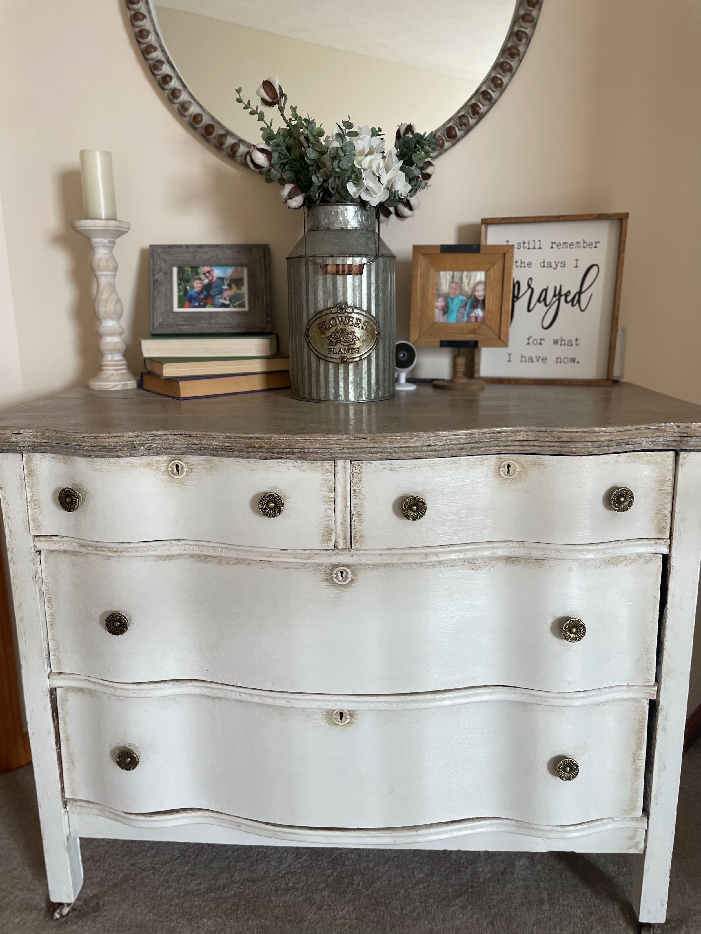 White finished dresser with decor on top 