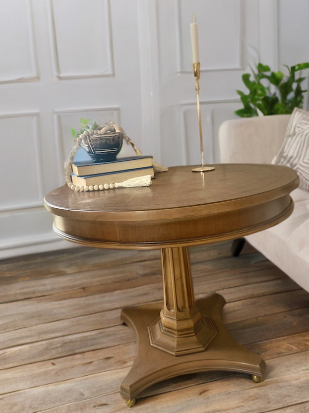 stained round table for living room with long candle stick on it 